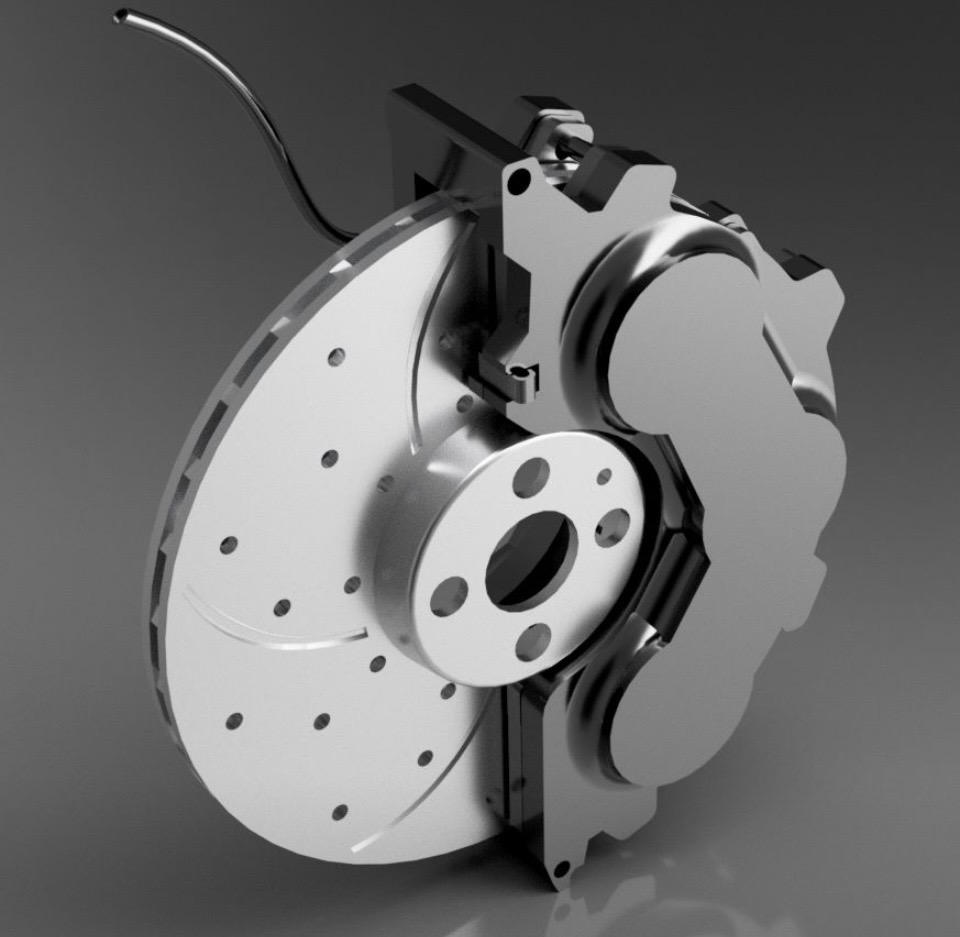 A 3D CAD model shows a disc brake assembly with a drilled rotor and six-cylinder fixed caliper. The rotor has evenly spaced holes and curved slots. The caliper sits beside the rotor with visible mounting brackets and a brake-line connection, showing how the components fit around the wheel hub.